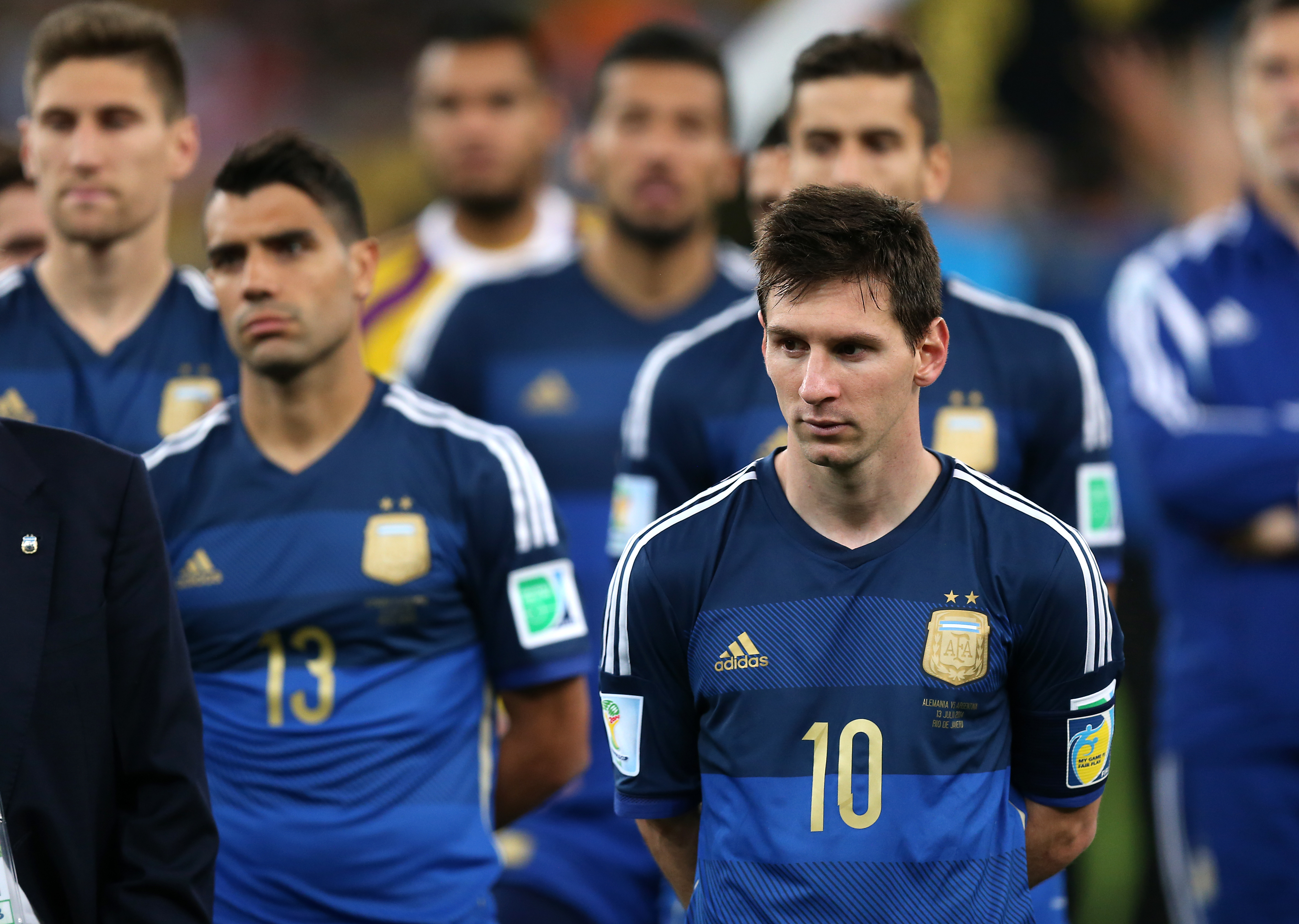 Argentina's Lionel Messi stands dejected as the Germany players receive the trophy (Photo by Mike Egerton/PA Images via Getty Images)