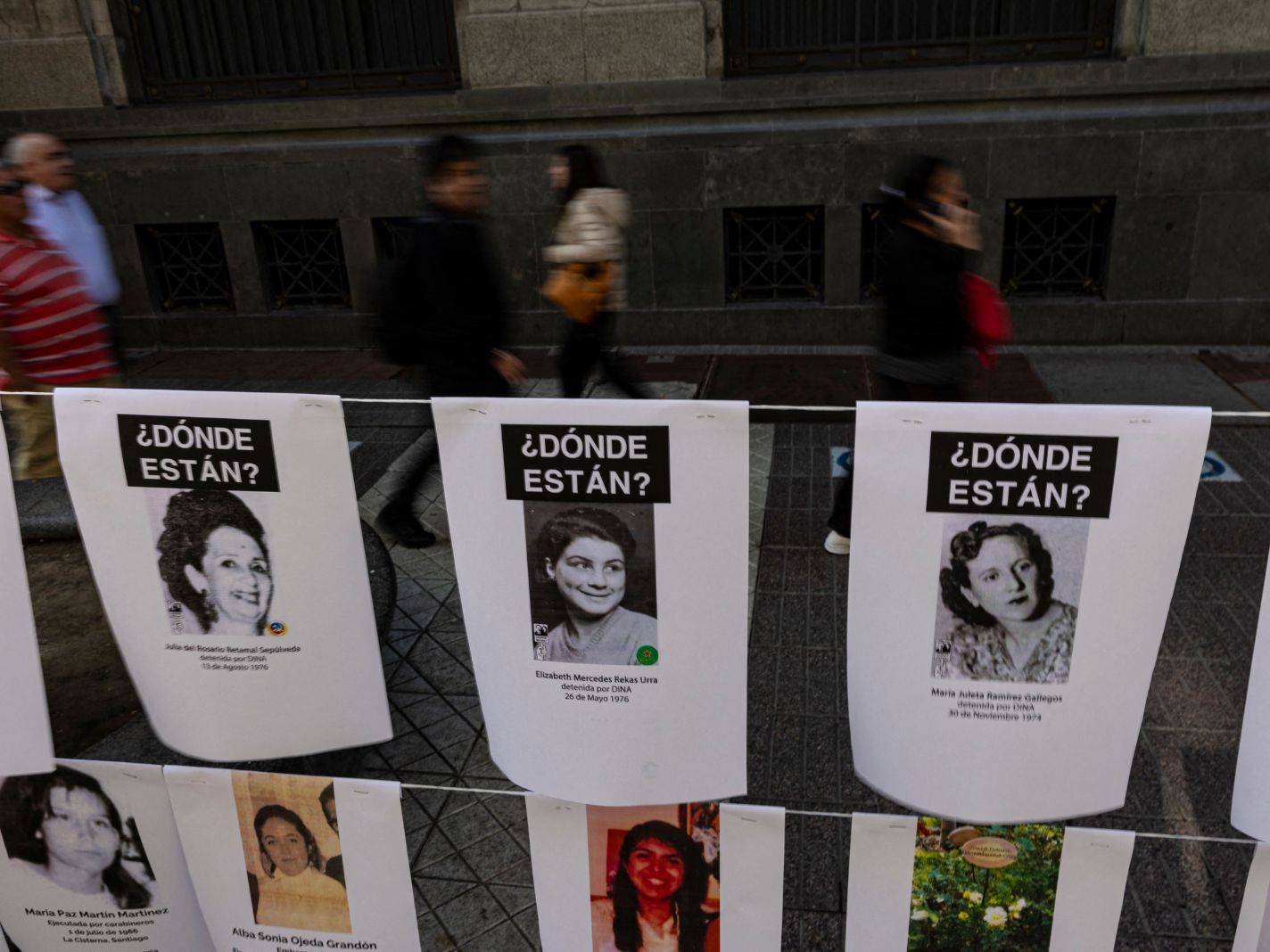 Pictures of women who disappeared and were politically executed during Augusto Pinochet's dictatorship (19731990) hang in a memorial installed by the Chilean Network against Violence against Women, in downtown Santiago on August 3, 2023. September 11 marks the 50th anniversary of the coup d'état led by General Augusto Pinochet that overthrew Chilean President Salvador Allende. (Photo by MARTIN BERNETTI / AFP) (Photo by MARTIN BERNETTI/AFP via Getty Images)
