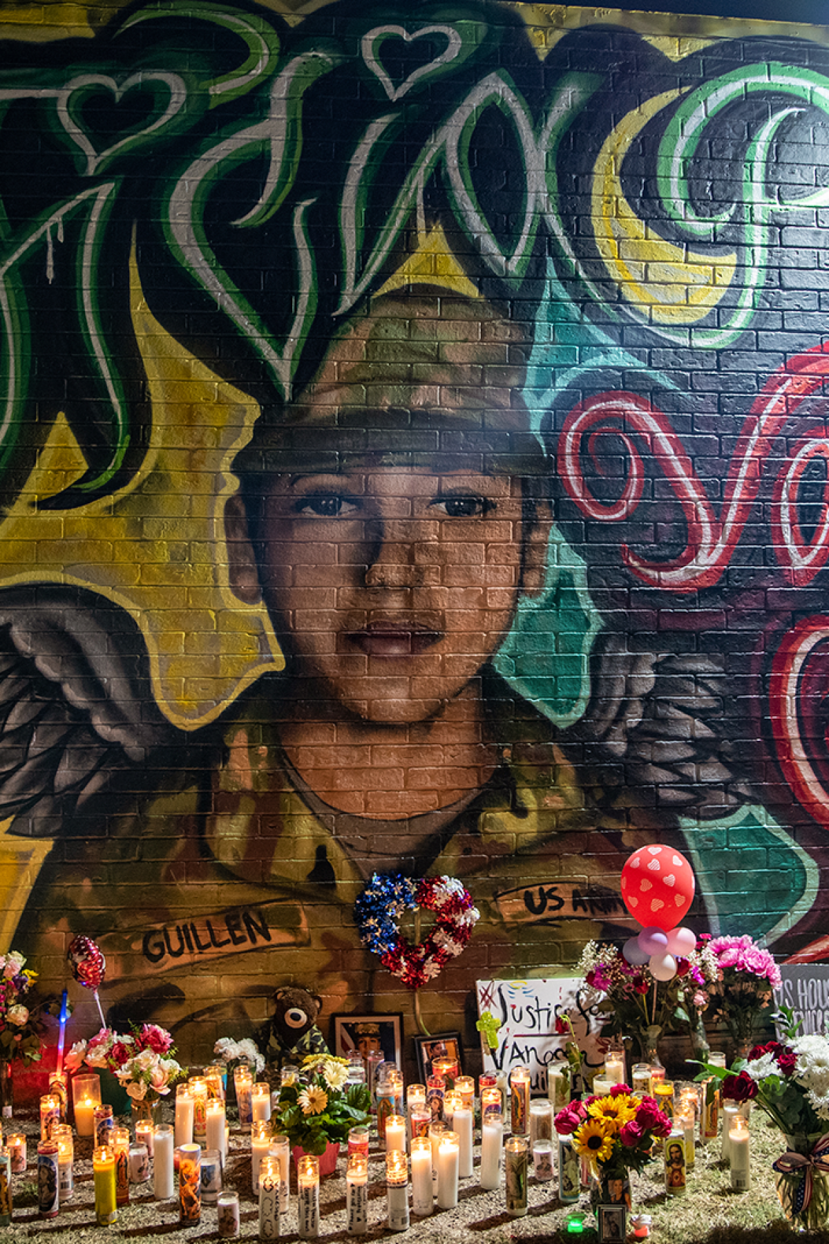 Flowers adorn a mural of Vanessa Guillen, a soldier based at nearby Fort Hood on July 6, 2020 in Austin, Texas. Photo by Sergio Flores/Getty Images