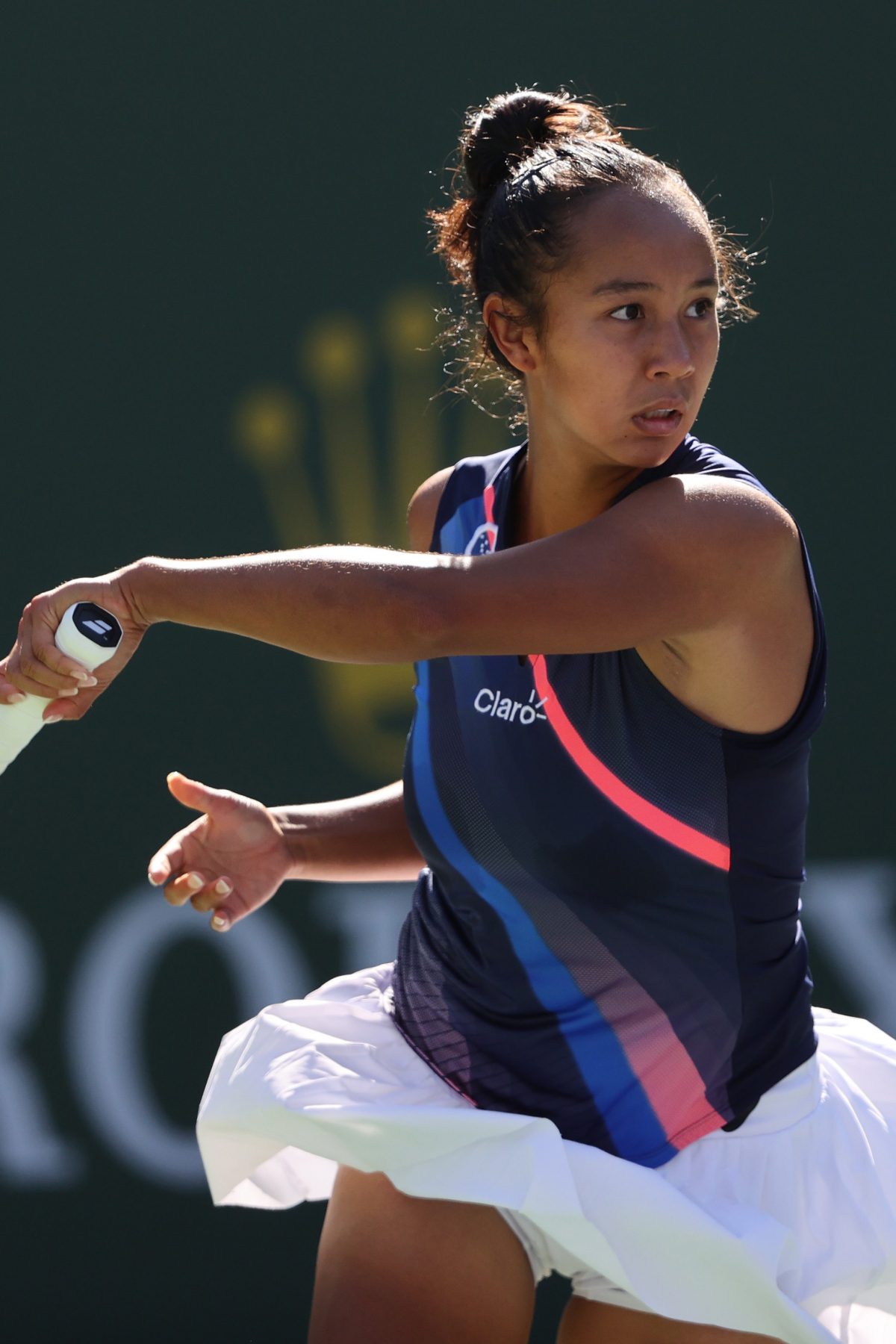 INDIAN WELLS, CALIFORNIA - OCTOBER 12: Leylah Fernandez of Canada plays a forehand against Shelby Rogers of the United States during fourth round match on Day 9 of the BNP Paribas Open at the Indian Wells Tennis Garden on October 12, 2021 in Indian Wells, California.