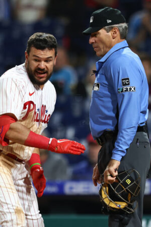 PHILADELPHIA, PA - APRIL 24: Kyle Schwarber #12 of the Philadelphia Phillies argues with home plate umpire Angel Hernandez after being called out on a third strike during the ninth inning of a game against the Milwaukee Brewers at Citizens Bank Park on April 24, 2022 in Philadelphia, Pennsylvania. The Brewers defeated the Phillies 1-0. (Photo by Rich Schultz/Getty Images)