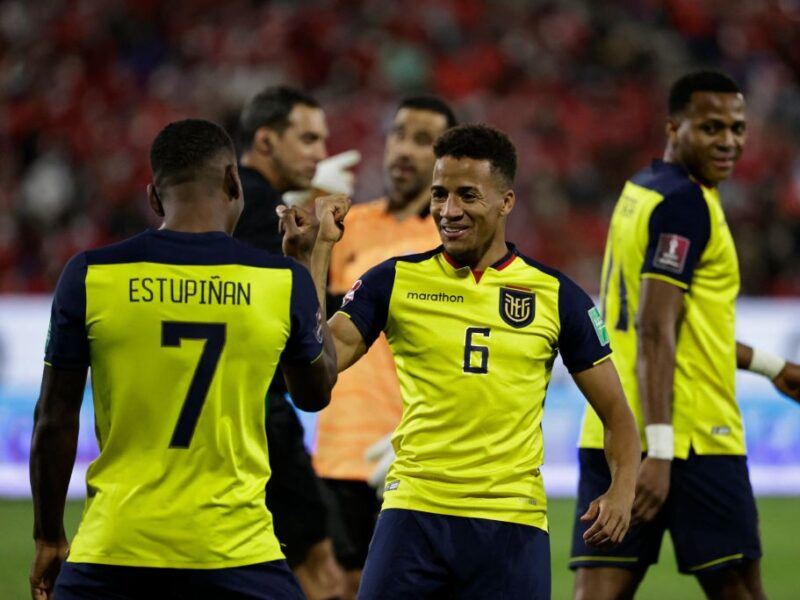 Ecuador's Pervis Estupinan (L) celebrates with teammate Byron Castillo after scoring against Chile during their South American qualification football match for the FIFA World Cup Qatar 2022 at the San Carlos de Apoquindo stadium in Santiago, on November 16, 2021. (Photo by ALBERTO VALDES / POOL / AFP) (Photo by ALBERTO VALDES/POOL/AFP via Getty Images)