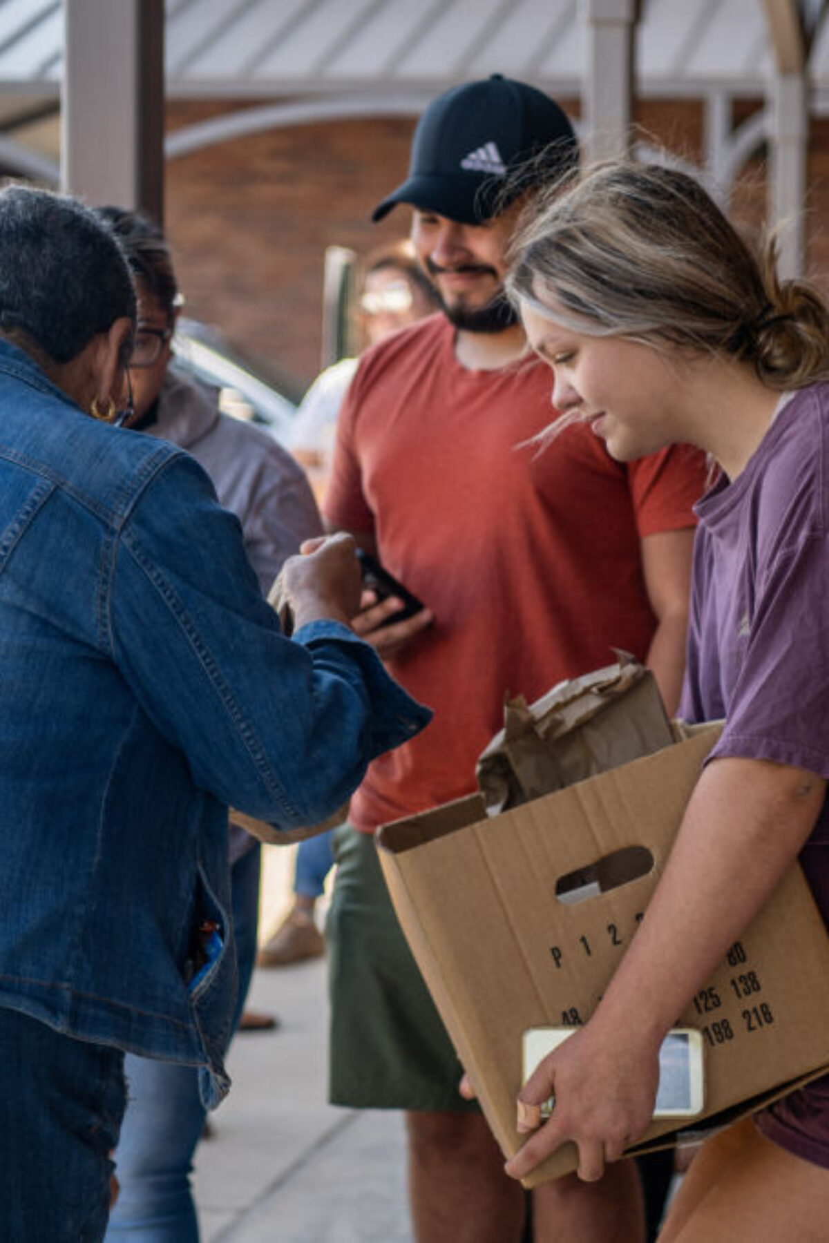 Uvalde community members distribute food to people waiting to donate blood at the South Texas Blood Bank's emergency blood drive on May 25, 2022.
