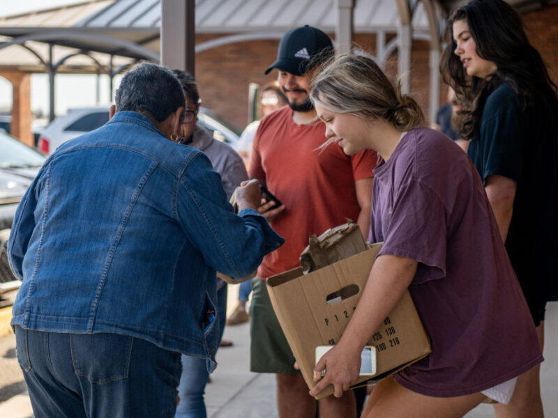 Uvalde community members distribute food to people waiting to donate blood at the South Texas Blood Bank's emergency blood drive on May 25, 2022.