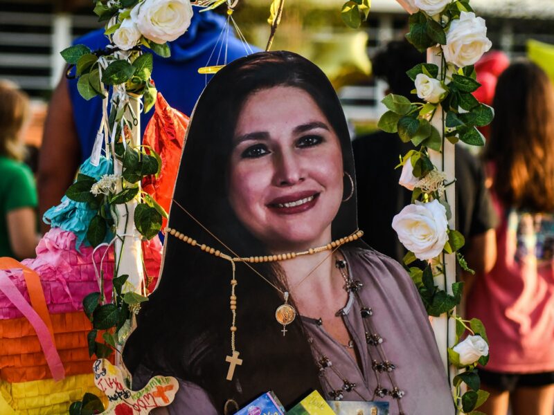 A photo of Irma Garcia, 48, who died in the mass shooting, is placed at a makeshift memorial at Robb Elementary School in Uvalde, Texas, on May 30, 2022. - Grieving families were to hold the first funerals Tuesday for Texas shooting victims one week after a school massacre left 19 children and two teachers dead, with President Joe Biden vowing to push for stricter US gun regulation. Mourners attended wakes in the town of Uvalde on Monday for some of the child victims gunned down by a local 18-year-old man who was then killed by police. (Photo by CHANDAN KHANNA / AFP) (Photo by CHANDAN KHANNA/AFP via Getty Images)