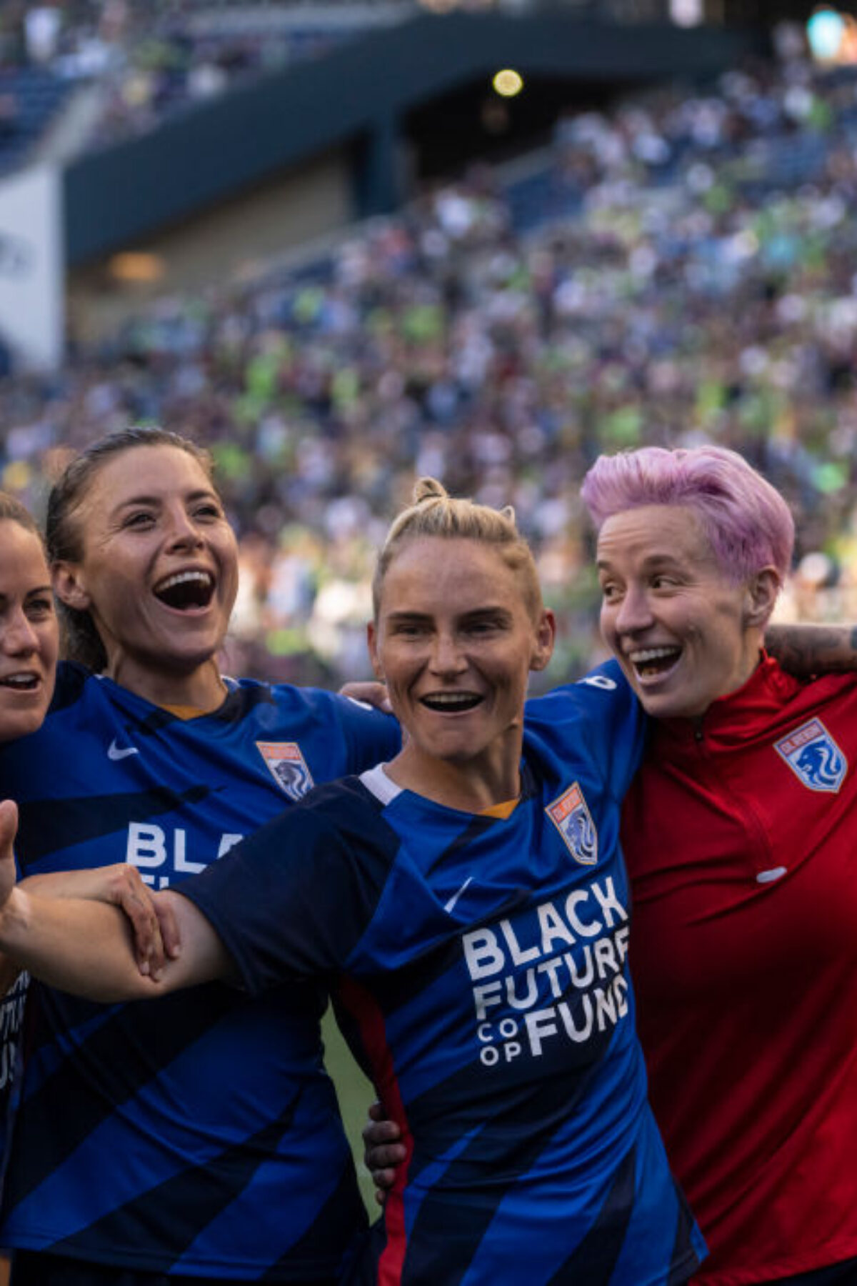 SEATTLE, WA - AUGUST 29: OL Reign Lauren Barnes #3, Sofia Huerta #11, Jessica Fishlock #10 and Megan Rapinoe #15 celebrate after a game between Portland Thorns FC and OL Reign at Lumen Field on August 29, 2021 in Seattle, Washington. (Photo by Stephen Brashear/ISI Photos/Getty Images)