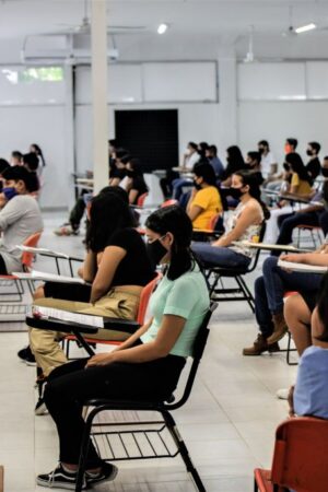 CANCUN, MEXICO - AUGUST 29: Students sit in a classroom as wait to take their entrance exam during an admission exam at CBTIS 111 on August 29, 2020 in Cancun, Mexico. Over 15,000 students sat for their high school admission exams of Quintana Roo. (Photo by Medios y Media/Getty Images)