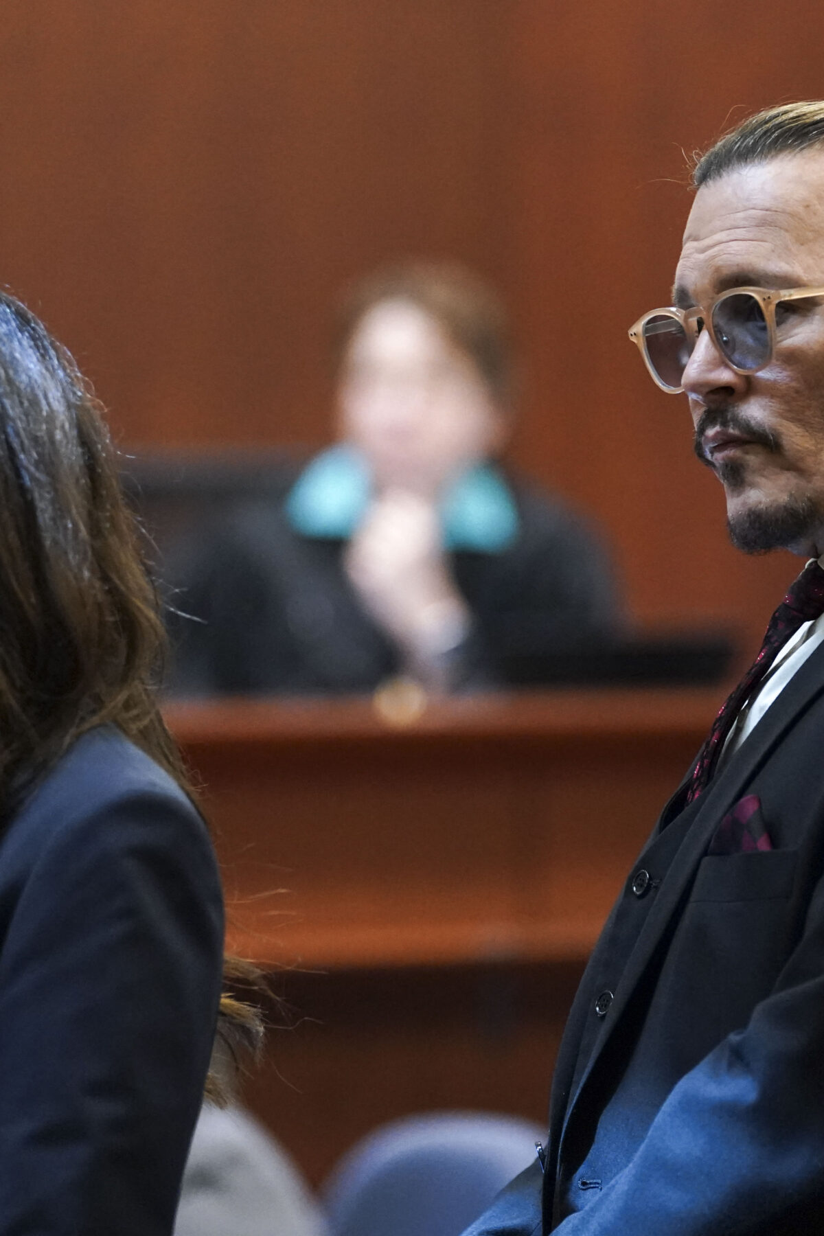 US actor Johnny Depp stands next to his lawyer Camille Vasquez after a break in the defamation trial against ex-wife Amber Heard at the Fairfax County Circuit Courthouse in Fairfax, Virginia, on May 18, 2022. - Depp is suing ex-wife Amber Heard for libel after she wrote an op-ed piece in The Washington Post in 2018 referring to herself as a public figure representing domestic abuse. (Photo by KEVIN LAMARQUE / POOL / AFP) (Photo by KEVIN LAMARQUE/POOL/AFP via Getty Images)