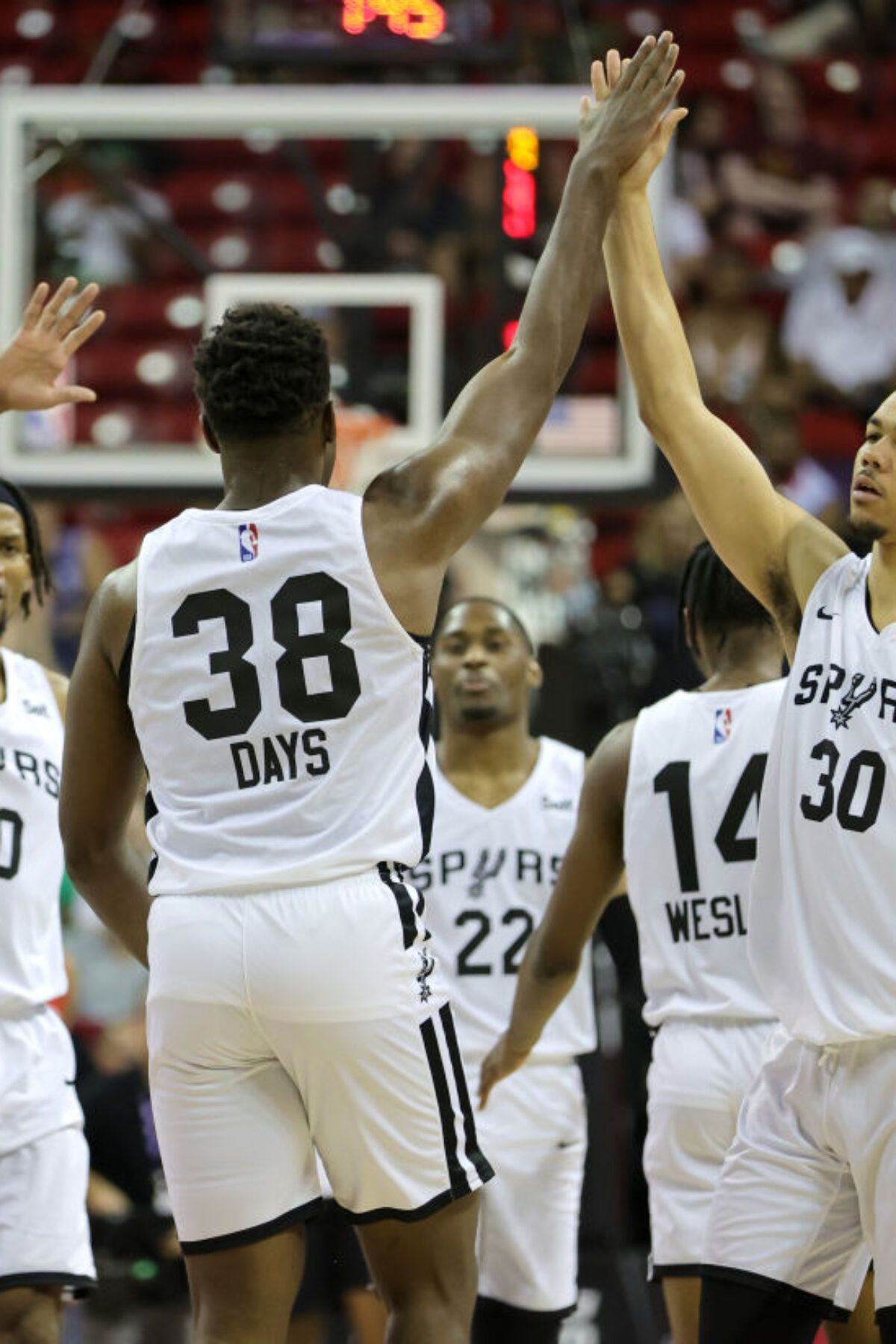 LAS VEGAS, NEVADA - JULY 11: Darius Days #38 of the San Antonio Spurs is congratulated by teammates Javin DeLaurier #40 and Jordan Hall #30 after Days hit a 3-pointer against the Houston Rockets during the 2022 NBA Summer League at the Thomas & Mack Center on July 11, 2022 in Las Vegas, Nevada. NOTE TO USER: User expressly acknowledges and agrees that, by downloading and or using this photograph, User is consenting to the terms and conditions of the Getty Images License Agreement. (Photo by Ethan Miller/Getty Images)