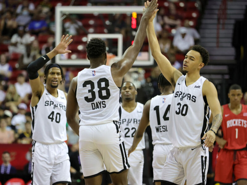 LAS VEGAS, NEVADA - JULY 11: Darius Days #38 of the San Antonio Spurs is congratulated by teammates Javin DeLaurier #40 and Jordan Hall #30 after Days hit a 3-pointer against the Houston Rockets during the 2022 NBA Summer League at the Thomas & Mack Center on July 11, 2022 in Las Vegas, Nevada. NOTE TO USER: User expressly acknowledges and agrees that, by downloading and or using this photograph, User is consenting to the terms and conditions of the Getty Images License Agreement. (Photo by Ethan Miller/Getty Images)
