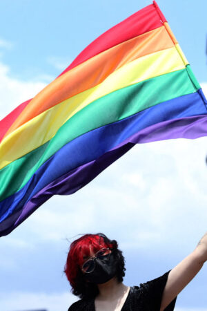 A person waves the rainbow flag, or pride flag, during the first in-person LGBT+ Pride march amid the novel coronavirus COVID-19 pandemic, in Guadalajara, Jalisco State, Mexico, on June 12, 2021. (Photo by Ulises RUIZ / AFP) (Photo by ULISES RUIZ/AFP via Getty Images)