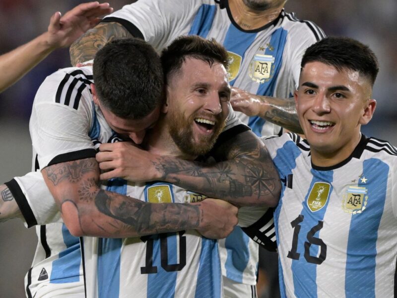 Argentina's forward Lionel Messi (C) celebrates with Argentina's midfielder Rodrigo De Paul (L) and Argentina's midfielder Thiago Almada after scoring a goal during the friendly football match between Argentina and Panama at the Monumental stadium in Buenos Aires, on March 23, 2023. - Lionel Messi capped a night of unbridled joy with the 800th goal of his career as world champions Argentina celebrated their homecoming with a 2-0 friendly victory over stubborn Panama in Buenos Aires on Thursday. (Photo by JUAN MABROMATA / AFP) (Photo by JUAN MABROMATA/AFP via Getty Images)