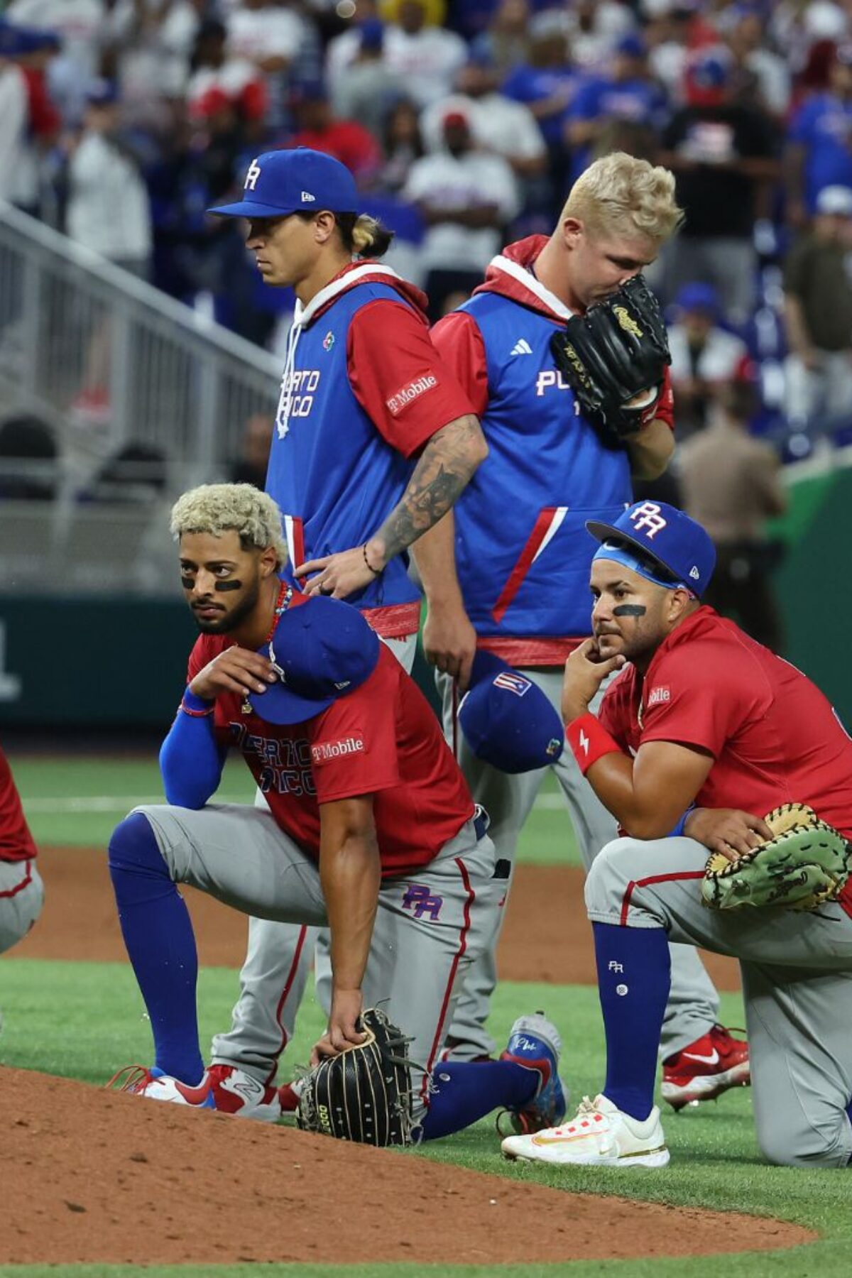 MIAMI, FLORIDA - MARCH 15: Members of Team Puerto Rico look on after Edwin Diaz #39 of Team Puerto Rico leaves the field in a wheelchair after sustaining an injury while celebrating a 5-2 win against Team Dominican Republic during their World Baseball Classic Pool D game at loanDepot park on March 15, 2023 in Miami, Florida. (Photo by Al Bello/Getty Images)