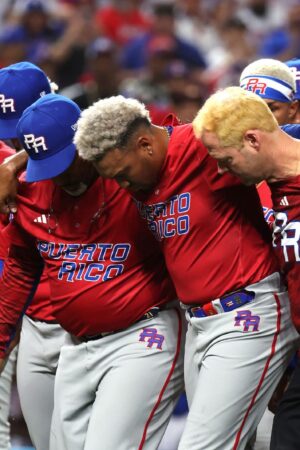 MIAMI, FLORIDA - MARCH 15: Edwin Diaz #39 of Team Puerto Rico is carried off the field after sustaining an injury while celebrating a 5-2 win against Team Dominican Republic during their World Baseball Classic Pool D game at loanDepot park on March 15, 2023 in Miami, Florida. (Photo by Al Bello/Getty Images)