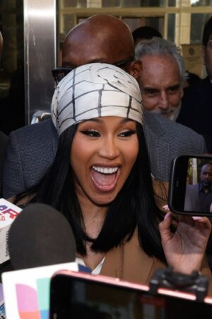 SANTA ANA, CALIFORNIA - OCTOBER 21: Cardi B is greeted by fans while departing the Ronald Reagan Federal Building and U.S. Courthouse on October 21, 2022 in Santa Ana, California. A jury ruled in Cardi B's favor after she was sued for copyright infringement for allegedly using an image of a man's tattoo on a mixtape cover. (Photo by Frazer Harrison/Getty Images)