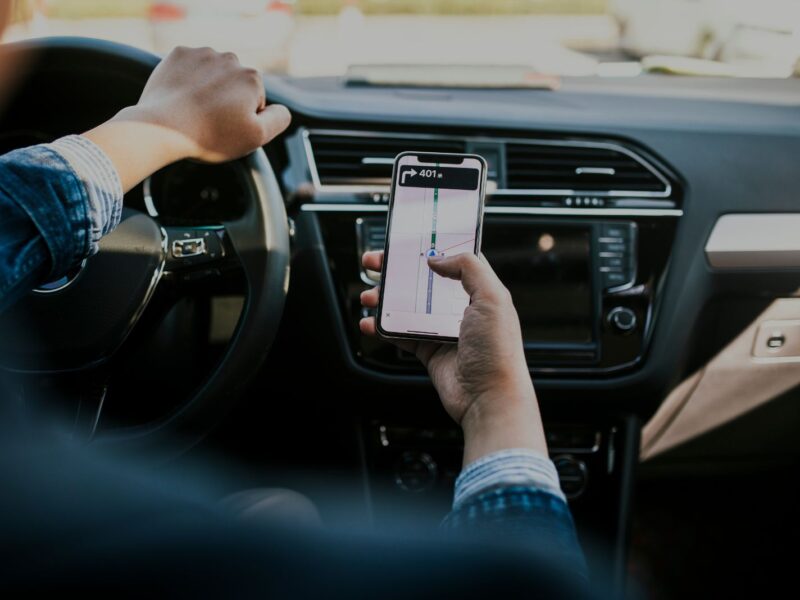 Smart phone mapping while in car - stock photo