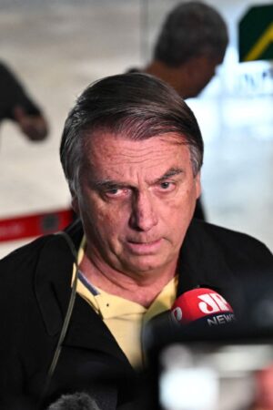 Former Brazilian President Jair Bolsonaro speaks to members of the media upon arrival at the Santos Dumont Airport in Rio de Janeiro, Brazil, on June 29, 2023. Judges will continue delivering verdicts Thursday on charges that far-right ex-president Jair Bolsonaro broke the law with his unproven allegations against Brazil's election system, which could see him banned from holding office for eight years. (Photo by MAURO PIMENTEL / AFP) (Photo by MAURO PIMENTEL/AFP via Getty Images)