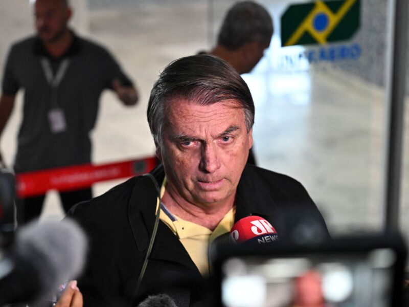 Former Brazilian President Jair Bolsonaro speaks to members of the media upon arrival at the Santos Dumont Airport in Rio de Janeiro, Brazil, on June 29, 2023. Judges will continue delivering verdicts Thursday on charges that far-right ex-president Jair Bolsonaro broke the law with his unproven allegations against Brazil's election system, which could see him banned from holding office for eight years. (Photo by MAURO PIMENTEL / AFP) (Photo by MAURO PIMENTEL/AFP via Getty Images)