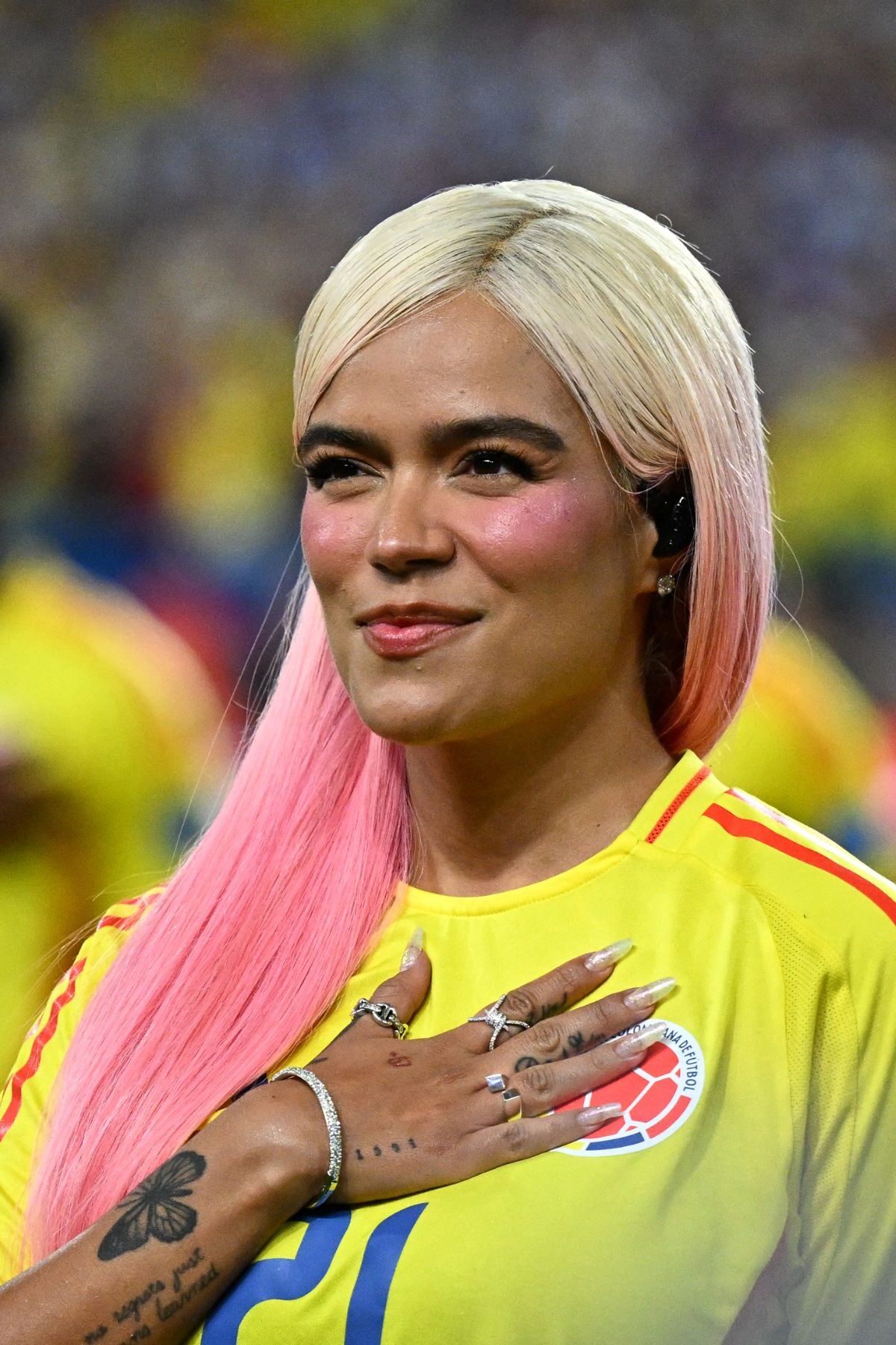 Colombian singer Karol G sings Colombia's national anthem before the Conmebol 2024 Copa America tournament final football match between Argentina and Colombia at the Hard Rock Stadium, in Miami, Florida on July 14, 2024. (Photo by Chandan Khanna / AFP) (Photo by CHANDAN KHANNA/AFP via Getty Images)