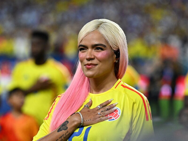 Colombian singer Karol G sings Colombia's national anthem before the Conmebol 2024 Copa America tournament final football match between Argentina and Colombia at the Hard Rock Stadium, in Miami, Florida on July 14, 2024. (Photo by Chandan Khanna / AFP) (Photo by CHANDAN KHANNA/AFP via Getty Images)