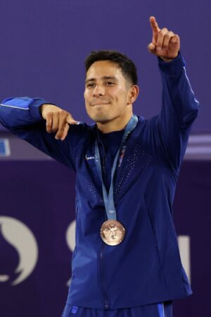 PARIS, FRANCE - AUGUST 10: Bronze medalist B-Boy Victor of Team United States celebrates on the podium during the Breaking B-Boys medal ceremony after the Breaking B-Boys Battles on day fifteen of the Olympic Games Paris 2024 at Place de la Concorde on August 10, 2024 in Paris, France. (Photo by Steph Chambers/Getty Images)