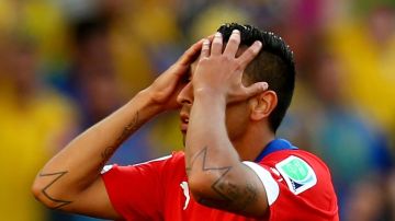Gonzalo Jara of Chile reacts after being defeated by Brazil in a penalty shootout during the 2014 FIFA World Cup Brazil round of 16 match between Brazil and Chile at Estadio Mineirao on June 28, 2014 in Belo Horizonte, Brazil. Photo by Ronald Martinez/Getty Images