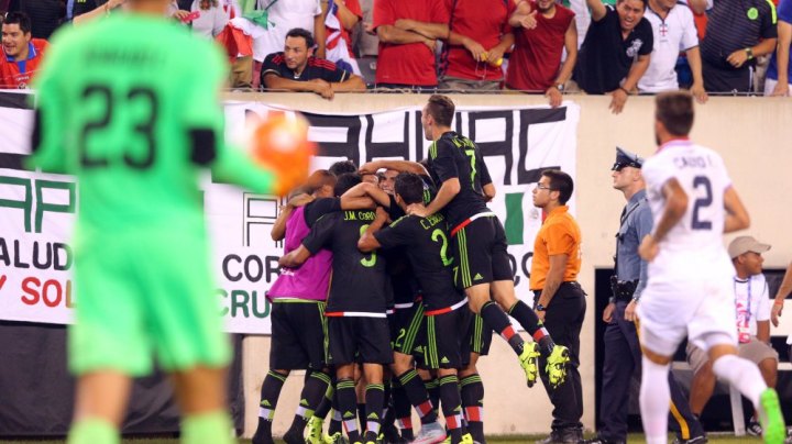 Jul 19, 2015; East Rutherford, NJ, USA; Mexico midfielder Andres Guardado (18) celebrates with teammates after kicking a penalty kick to score a goal against Costa Rica goalkeeper Esteban Alvarado (23) during stoppage time of the overtime period of a CONCACAF Gold Cup quarterfinal match at MetLife Stadium. Mexico won 1-0 in overtime. Mandatory Credit: Brad Penner-USA TODAY Sports ORG XMIT: USATSI-230456 ORIG FILE ID: 20150719_ads_ae5_226.JPG