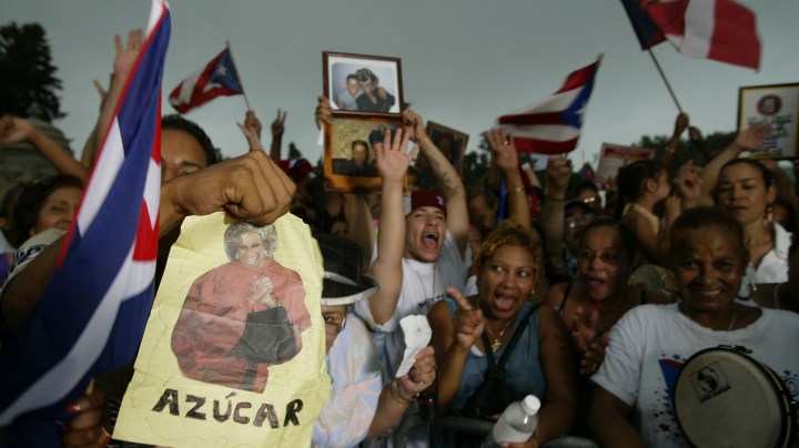 Fans attend a public ceremony for Celia Cruz at Woodlawn Cemetery before the casket was taken for a private burial July 22, 2003 in the Bronx borough of New York City.  Photo by Mark Mainz/Getty Images