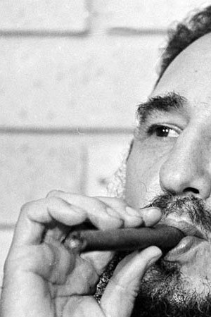 Fidel Castro, Prime Minister of Cuba, smokes a cigar during his meeting with two U.S. senators, the first to visit Castro's Cuba, in Havana, Cuba, Sept. 29, 1974.  (AP Photo)