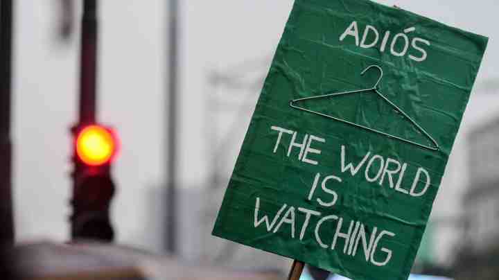 Detail of a Pro legal abortion sign that reads 'Goodbye, the world is watching' in front of the National Congress Building while senators vote for the new abortion law on August 8, 2018 in Buenos Aires, Argentina. Photo by Amilcar Orfali/Getty Images