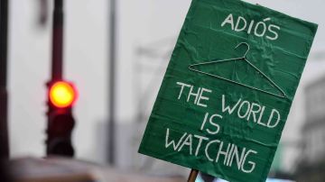 Detail of a Pro legal abortion sign that reads 'Goodbye, the world is watching' in front of the National Congress Building while senators vote for the new abortion law on August 8, 2018 in Buenos Aires, Argentina. Photo by Amilcar Orfali/Getty Images