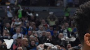 Karl-Anthony Towns #32 of the Minnesota Timberwolves hugs his parents, Karl and Jackie Towns after winning the game against the Denver Nuggets. Photo by Hannah Foslien/Getty Images