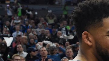 Karl-Anthony Towns #32 of the Minnesota Timberwolves hugs his parents, Karl and Jackie Towns after winning the game against the Denver Nuggets. Photo by Hannah Foslien/Getty Images