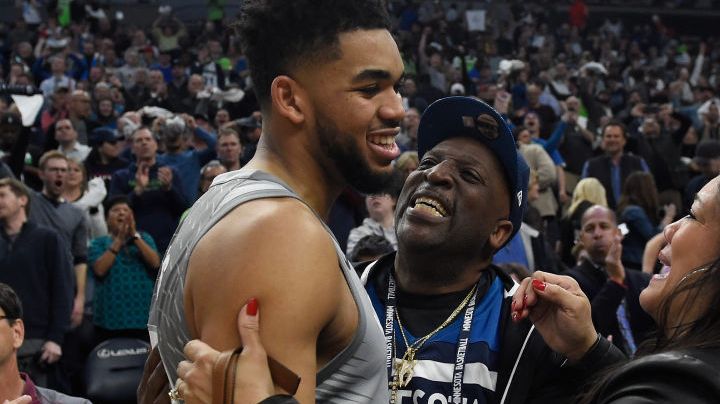 Karl-Anthony Towns #32 of the Minnesota Timberwolves hugs his parents, Karl and Jackie Towns after winning the game against the Denver Nuggets. Photo by Hannah Foslien/Getty Images