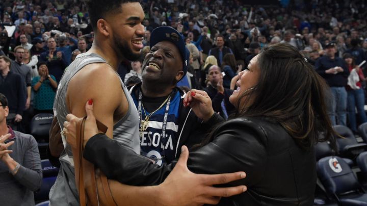 Karl-Anthony Towns #32 of the Minnesota Timberwolves hugs his parents, Karl and Jackie Towns after winning the game against the Denver Nuggets. Photo by Hannah Foslien/Getty Images