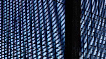 Multimedia artist Zeke Peña next to the El Paso-Júarez border fence. Photo by Itzel Alejandra Martinez