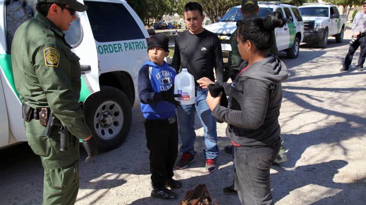 Border Patrol agents take a family from El Salvador into custody at the city cemetery for illegally entering the United States by crossing the Rio Grande River. The family, from San Vicente, was fleeing gang violence, which is rampant in El Salvador. Photo b Vichinterlang /Editorial RF