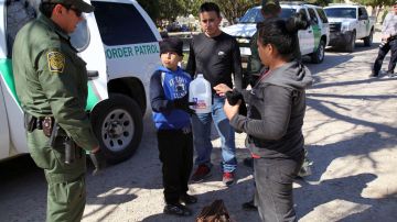Border Patrol agents take a family from El Salvador into custody at the city cemetery for illegally entering the United States by crossing the Rio Grande River. The family, from San Vicente, was fleeing gang violence, which is rampant in El Salvador. Photo b Vichinterlang /Editorial RF