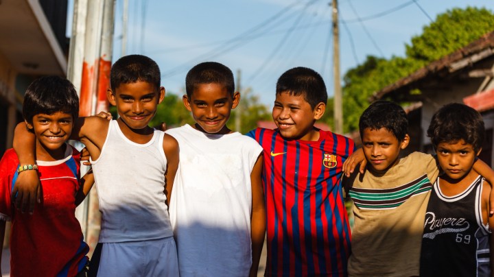 Group of young boys playing street soccer pose for photo. Soccer is one of the most popular national sports of Nicaragua and the world. Photo by Pniesen/ iStock Editorial / Getty Images Plus
