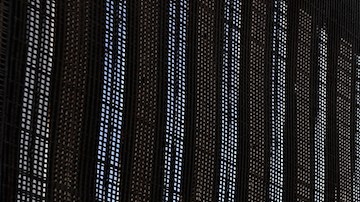 A man stands next to the U.S.-Mexico border fence at Friends of Friendship Park on February 4, 2017 in San Ysidro, California. Photo by Justin Sullivan/Getty Images  News
