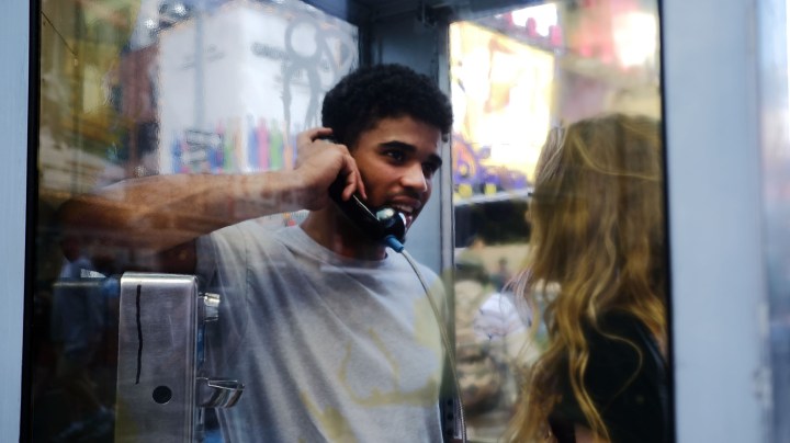 Jerome Farah stands in a repurposed telephone booth in Times Square listening to artist Aman Mojadidi interactive public art installation 'Once Upon a Place' on June 27, 2017 in New York City. Photo by Spencer Platt/Getty Images News