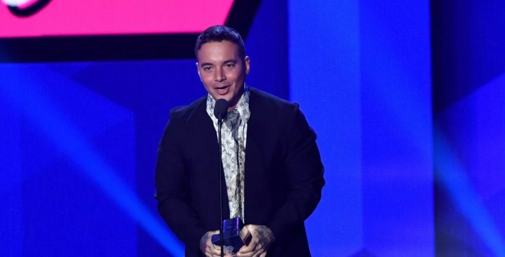J Balvin accepts an award on stage during Univision's "Premios Juventud." Photo by Rodrigo Varela/Getty Images Entertainment