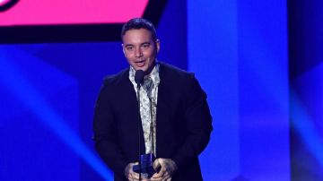 J Balvin accepts an award on stage during Univision's "Premios Juventud."   Photo by Rodrigo Varela/Getty Images Entertainment