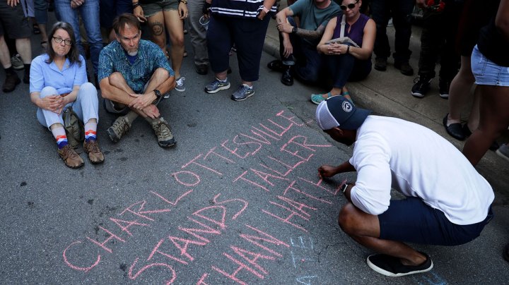 Hundreds of people gather for a vigil on the spot where 32-year-old Heather Heyer was killed when a car plowed into a crowd of people protesting against the white supremacist Unite the Right rally August 13, 2017 in Charlottesville, Virginia. Photo by Chip Somodevilla/Getty Image News
