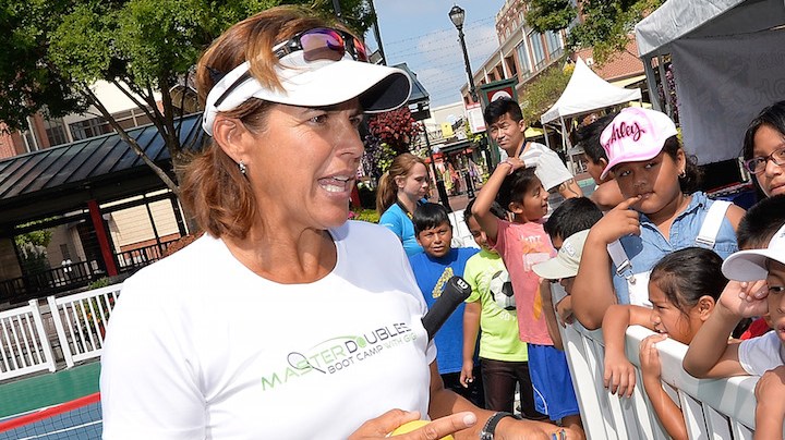 Tennis legend Gigi Fernandez shows her to Olympic gold medals as she meets with young Hispanic fans during a clinic Photo by Grant Halverson/Getty Images Sport