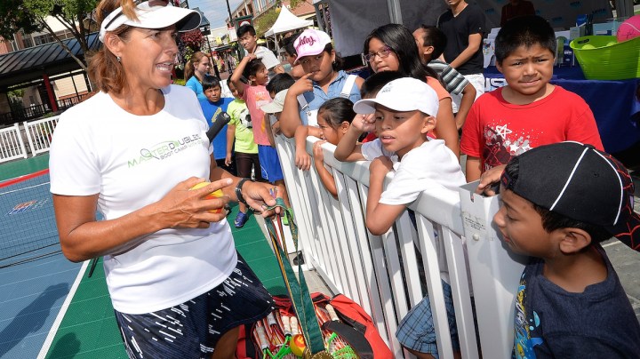 Tennis legend Gigi Fernandez shows her to Olympic gold medals as she meets with young Hispanic fans during a clinic Photo by Grant Halverson/Getty Images Sport