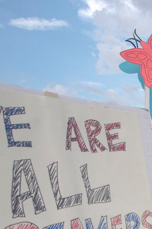 People hold signs over the 110 freeway as thousands of immigrants and supporters join the Defend DACA March to oppose the President Trump order to end DACA on September 10, 2017 in Los Angeles, California. Photo by David McNew/Getty Images News