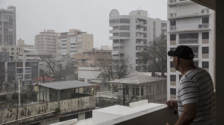 A resident looks out over the Miramar neighborhood after Hurricane Maria made landfall on September 20, 2017 in San Juan, Puerto Rico. Photo by Alex Wroblewski/Getty Images News