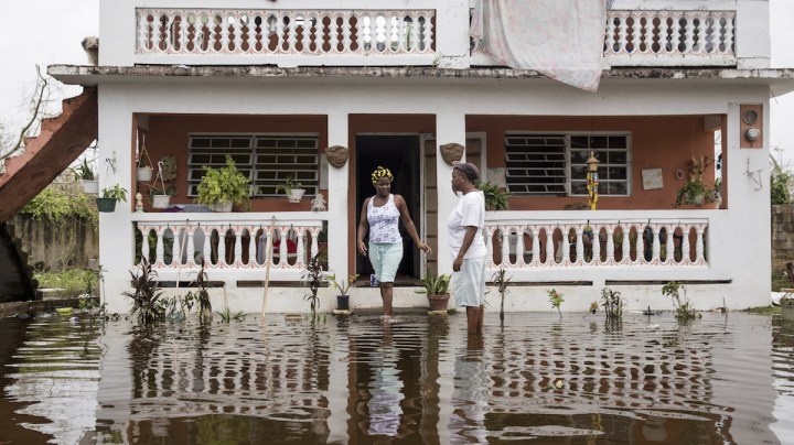 Residents wade through flood waters at their home days after Hurricane Maria made landfall, on September 22, 2017 in Loiza, Puerto Rico. Photo by Alex Wroblewski/Getty Images News