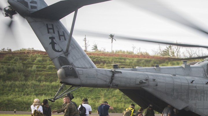 In this handout image provided by the U.S.Navy,  U.S. citizens board a U.S. Marine Corps CH-53E Super Stallion helicopter. Photo by   Ian Leonesz/US Marine Corps via Getty Images News